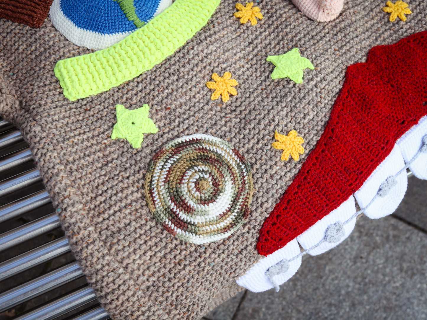 Close-up of a textured surface with colorful star patterns and a spiral design.