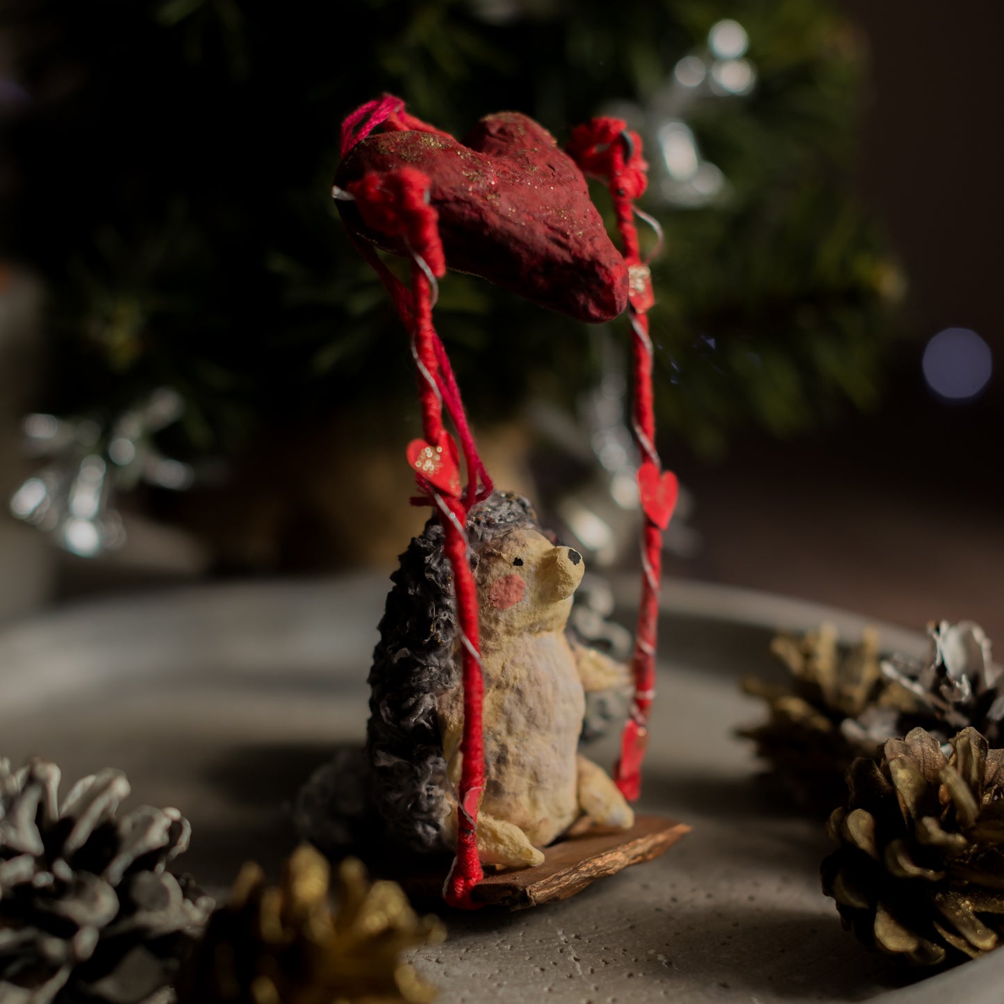 Handmade spun cotton hedgehog ornament with pinecone-style texture