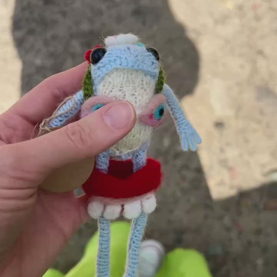 Close-up of cute frog plushie with cozy pullover