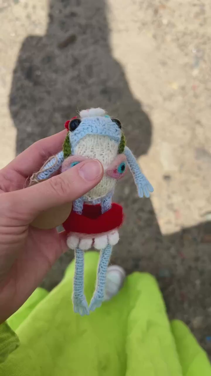 Close-up of cute frog plushie with cozy pullover